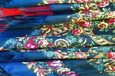 Texture background, pattern. Different fabrics stacked on a table in a pile