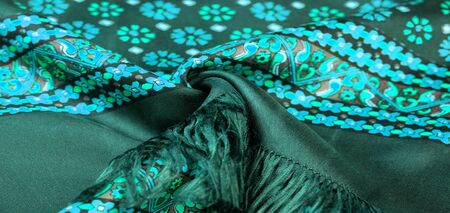 silk fabric of green color with blue and white flowers, dense fabric, bilateral on the basis of...