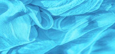 Texture, background, pattern, collection, wrinkled silk fabric "electric" blue. 3D pleated wrinkled and wrinkled light camel fabric made of pure silkの写真素材
