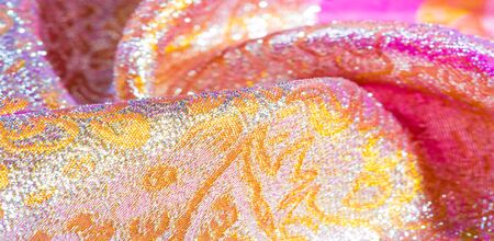 Texture background, pattern. pink brocade fabric. Organza brocade fabric - shepherd, with a crunchy palm. It has a large yarn-dyed flower embroidered pattern throughout.の写真素材