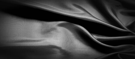 texture, background, pattern. Black silk fabric. It is black and heat resistant with gray. Transform its tougher drape into a design for any event. It is a crispy, lightly textured hand.の写真素材