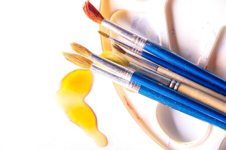 The artist paints with brushes. easel. watercolor. White background. The one who creatively works in a-n. field of art.の写真素材