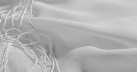 Background, pattern, texture, wallpaper, white silk fabric has a brilliant shine. This is the most versatile fabric. Be creative with beautiful accents of your design.の写真素材