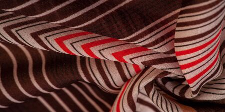 Texture, pattern, collection, silk fabric, brown background with a striped pattern of white and red lines, the Spanish theme, which is great for the design of procedures and projects.の写真素材