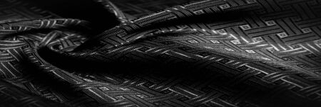 Background texture, pattern. Black silk fabric with a small checkered pattern. You do not need smoke and mirrors, this Katia smoky gray checkered SILK yarn speaks for itself. creates airy fabricの写真素材