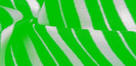 silk striped fabric. green white stripes. This beautiful, super soft, medium-sized silk blend is perfect for your design projects. It is brushed on the back for a luxurious feeling.の写真素材