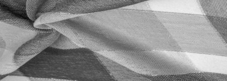 Texture, background, silk scarf feminine black and white with a metal stripe. The scarf is decorated...