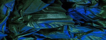texture background pattern wallpaper silk fabric black with blue emerald stripes, wrinkled fabric, your project will acquire sophistication and brevity this unusual texture is exactly what you needの写真素材