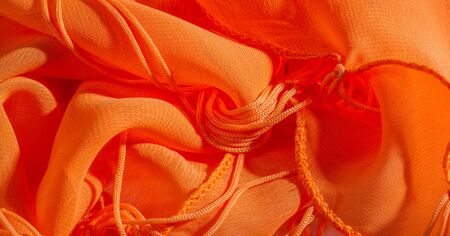 background, pattern, texture, Orange silk fabric has a brilliant luster. It folds into soft folds...