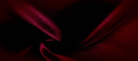 texture, red silk fabric panoramic photo. Silk Duke mood satin - beautiful and regal. It has a darker luster, then the usual satin on the one hand, has an average weight and has a more solid hand.の写真素材