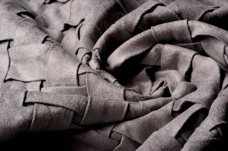 Textured, background, pattern, Woven fabric of intertwined folded strips of gray. Fashionable interior design, web pages, and other.の写真素材