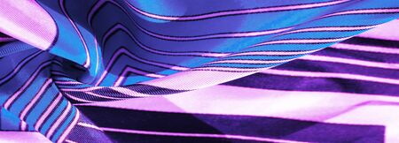 Texture, background, silk fabric with a blue striped pattern. The design of this fabric is devoted to a patchwork mosaic in the style of a white rabbit, representing what a fairytale's vest might look like.の写真素材