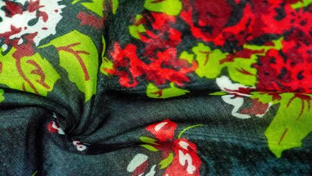Texture background, dark blue silk fabric with roses painted colors, colors are blue red white green red white greenの写真素材