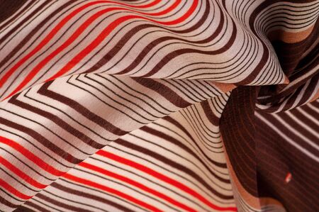 Texture, pattern, collection, silk fabric, brown background with a striped pattern of white and red lines, the Spanish theme, which is great for the design of procedures and projects.の写真素材
