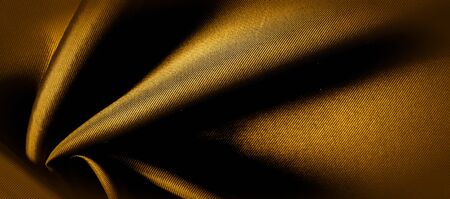 texture, background, pattern. golden yellow silk fabric panoramic photo. This is sunny carolina. This is a smooth hand that creates a subtle sheen. Made with luxurious silk, like beauty!の写真素材