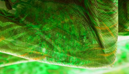 Background texture, pattern. Silk from a greenish emerald shade. This luxurious silk chiffon fabric...