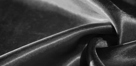 Texture, background, pattern, silk fabric in black. This adorable, soft and shiny fabric has a smooth mink surface, perfect for creating your projects.の写真素材