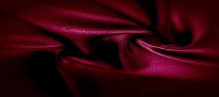 texture, red silk fabric panoramic photo. Silk Duke mood satin - beautiful and regal. It has a darker luster, then the usual satin on the one hand, has an average weight and has a more solid hand.の写真素材