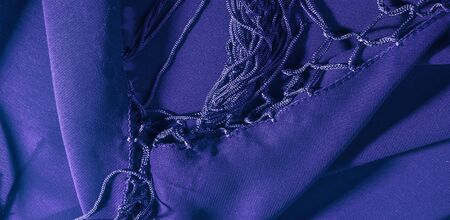 Background texture of silk fabric. This is a natural purple blue scarf, this beautiful nylon satin made of rayon with a transparent hand and a wonderful sheen is perfect for your projects.の写真素材
