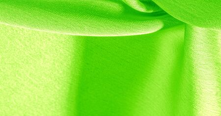 Background, pattern, texture, wallpaper, green silk fabric. It has a smooth matte finish. Use this luxurious fabric for anything - from design to your projects. The possibilities are truly endless!の写真素材