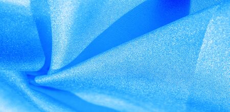 Texture, background, pattern, silk fabric in blue. This silk is incredibly exquisite. Projects made from this will last a long time and will still be in fairly good condition.の写真素材