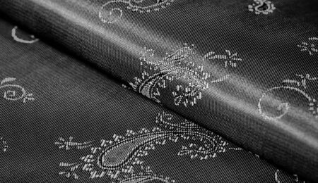 Texture, Black silk chiffon fabric with paisley print. fabulous soft and dark fabric, with a beautiful paisley pattern in gray, it would be just as beautiful for your design, wallpaper, postersの写真素材