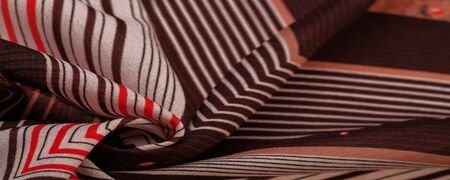 Texture, pattern, collection, silk fabric, brown background with a striped pattern of white and red lines, the Spanish theme, which is great for the design of procedures and projects.の写真素材