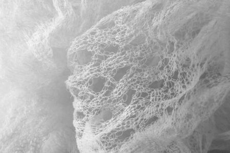 Texture background pattern white fabric in a mesh Thanks to a unique combination and clean design this is an impressive fabric It is great for all kinds of your design, decor, decorations, wallpapersの写真素材
