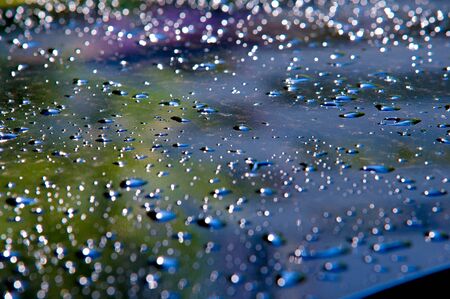 The photo is blurred, raindrops on the car paintworkの写真素材