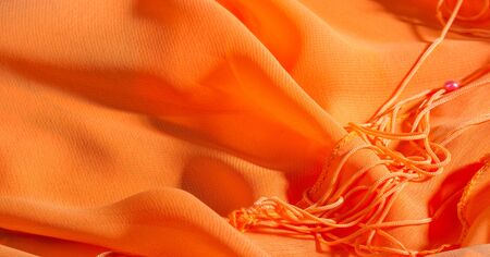 background, pattern, texture, Orange silk fabric has a brilliant luster. It folds into soft folds when draping and is the most versatile fabric. Be creative with beautiful accents of your design.の写真素材