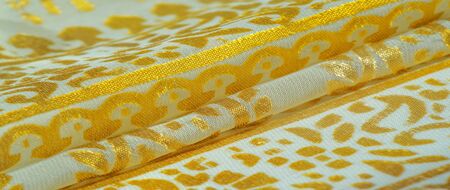 Texture, pattern, collection, silk fabric, female scarf, golden pastel on a beige background,...