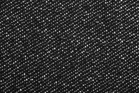 Texture, background, pattern. Cloth Gray black coated with a metallic silver thread. These fabrics are ideal for any project, wallpaper, all design solutions. and many uses of ships.の写真素材