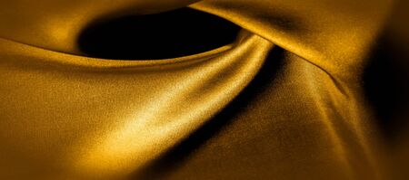 texture, background, pattern. golden yellow silk fabric panoramic photo. This is sunny carolina. This is a smooth hand that creates a subtle sheen. Made with luxurious silk, like beauty!の写真素材