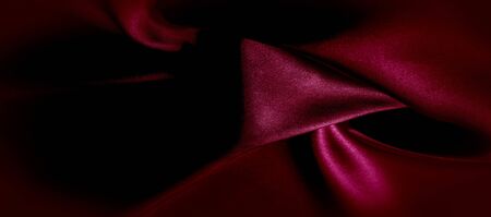 texture, red silk fabric panoramic photo. Silk Duke mood satin - beautiful and regal. It has a darker luster, then the usual satin on the one hand, has an average weight and has a more solid hand.の写真素材