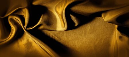 texture, background, pattern. golden yellow silk fabric panoramic photo. This is sunny carolina. This is a smooth hand that creates a subtle sheen. Made with luxurious silk, like beauty!の写真素材