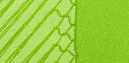 Background texture of silk fabric. This is a natural green salad scarf, this beautiful nylon satin...