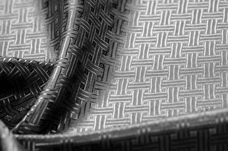 Background texture, pattern. Black silk fabric with a small checkered pattern. You do not need smoke and mirrors, this Katia smoky gray checkered SILK yarn speaks for itself. creates airy fabricの写真素材