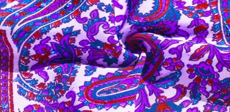 Background texture, pattern, paisley fabric cotton.  Designed by Kaffe Fassett for Free Spirit, the color palette of this large paisley is shades of green with hot pink, cobalt blue, fuchsia and purple.の写真素材