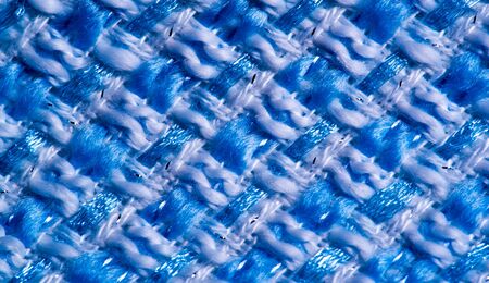 Texture, fabric, pattern. Large weave of blue and white threads, tightly woven fabric with a very...