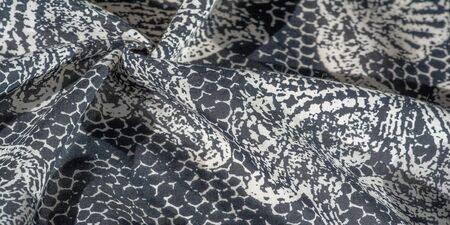 Background texture. cotton women scarf black and white pattern on one side of the scarf and color...