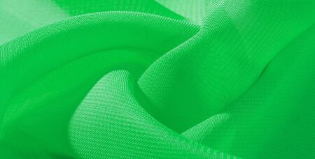 texture background pattern green silk fabric. This silk organza has a gentle open weave. Use this luxurious fabric for anything from your design for special occasions to creating your projects.の写真素材