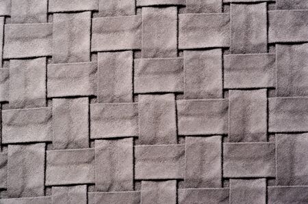 Textured, background, pattern, Woven fabric of intertwined folded strips of gray. Fashionable interior design, web pages, and other.の写真素材