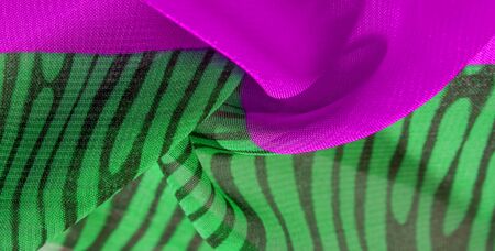 texture background pattern wallpaper. Green pink black silk fabric pattern. This medium-weight rayon fabric has a nice shine with slight color variations. Perfect for adding elegance to your designsの写真素材