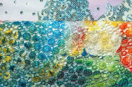 background texture; pattern. Cloth with glued lace stripes. Multicolored lace with sparkles; cording...