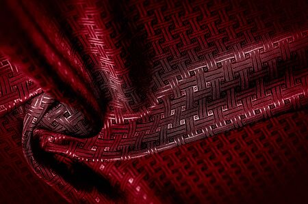 Background texture, pattern. Red silk fabric with a small checkered pattern. A classic look, add...