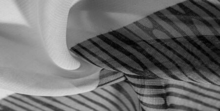 texture, background, pattern, wallpaper. Black white silk fabric pattern. This medium-weight rayon fabric has a nice shine with slight color variations. Perfect for adding elegance to your designs.の写真素材