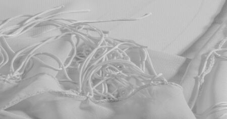 Background, pattern, texture, wallpaper, white silk fabric has a brilliant shine. This is the most versatile fabric. Be creative with beautiful accents of your design.の写真素材