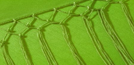 Background texture of silk fabric. This is a natural green salad scarf, this beautiful nylon satin...