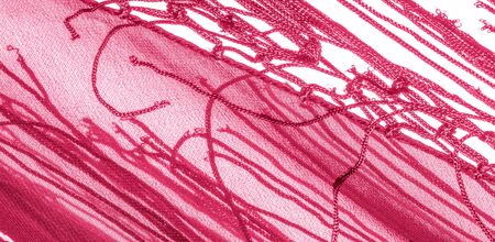 Background texture of silk fabric. This is a natural red scarf, this beautiful nylon satin made of...