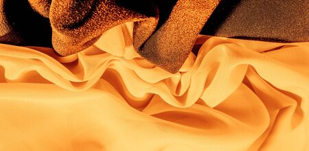 texture background pattern. Yellow silk fabric with a subtle matte sheen. It is perfect for your design, accents, wallpapers, posters and postcards.の写真素材